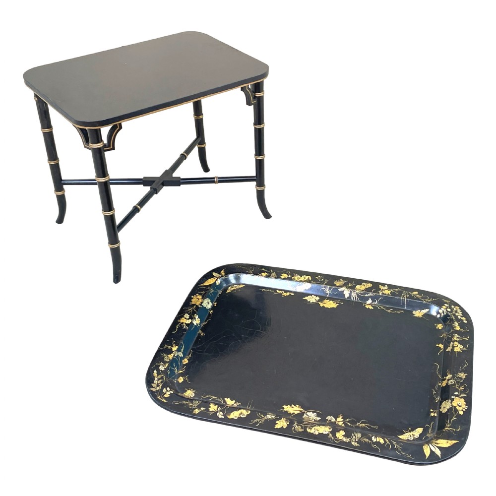 A black lacquered rectangular papier-mache tray table with gilded floral decorations set on ebonised faux bamboo legs. View IX