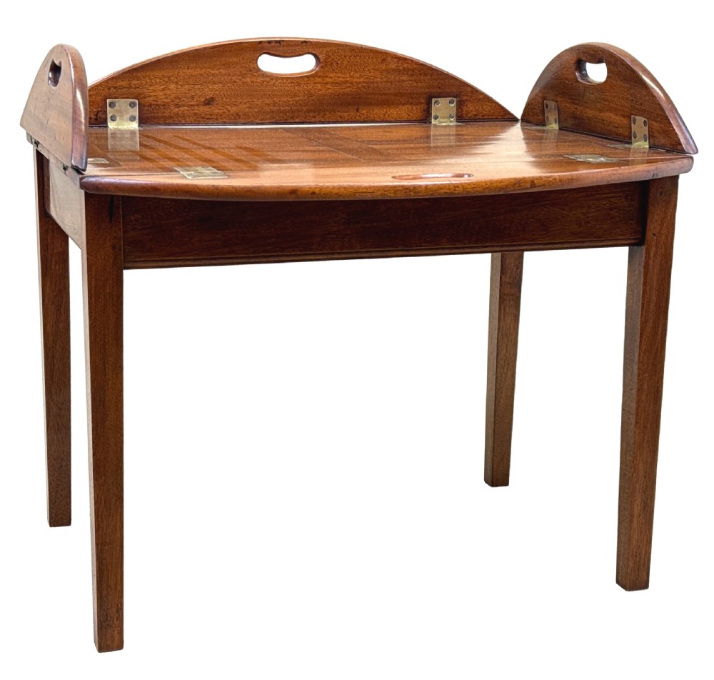 A Georgian mahogany oval butler tray table featuring brass-hinged drop sides with cut-out hand-grips resting on four square legs. View II