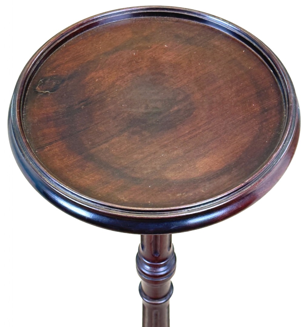 An 18th-century mahogany torchere stand featuring a circular dished top, a slender fluted stem, and a tripod base. View VI