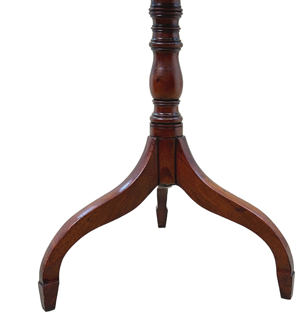 A Regency mahogany tilt-top wine table featuring a rectangular surface with rounded corners, supported by a turned central pedestal and a tripod base. View V
