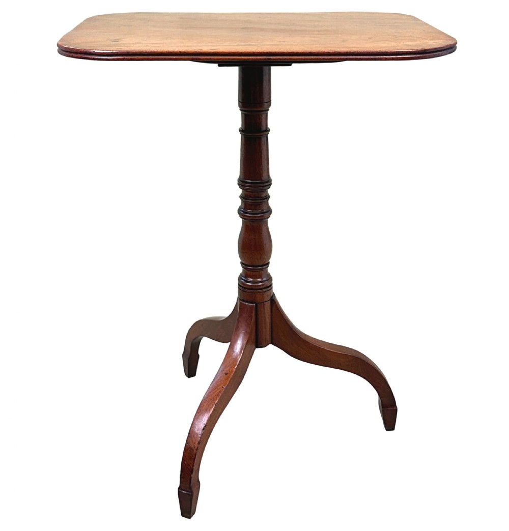 A Regency mahogany tilt-top wine table featuring a rectangular surface with rounded corners, supported by a turned central pedestal and a tripod base. View VI