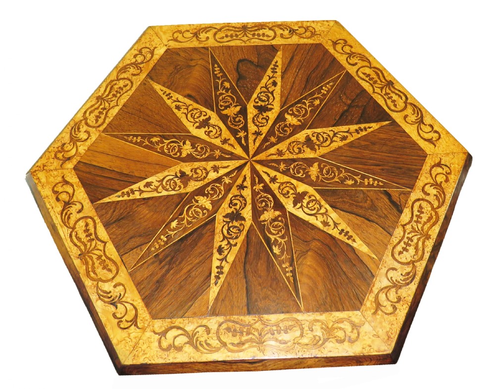 A mid-19th century hexagonal occasional table featuring geometric specimen wood marquetry on a central carved pedestal with tripod scroll legs. View II