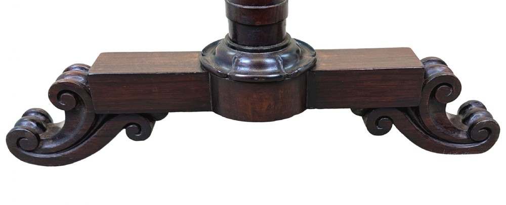 A late Regency rosewood occasional table with slender turned upright supports, a turned stretcher, and carved scroll feet. View VII