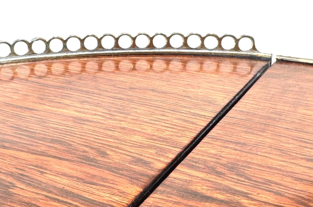 A dark rosewood Regency games table featuring slender ring-turned legs, a pierced brass gallery railing on top, and brass mounts on splayed feet. View VII