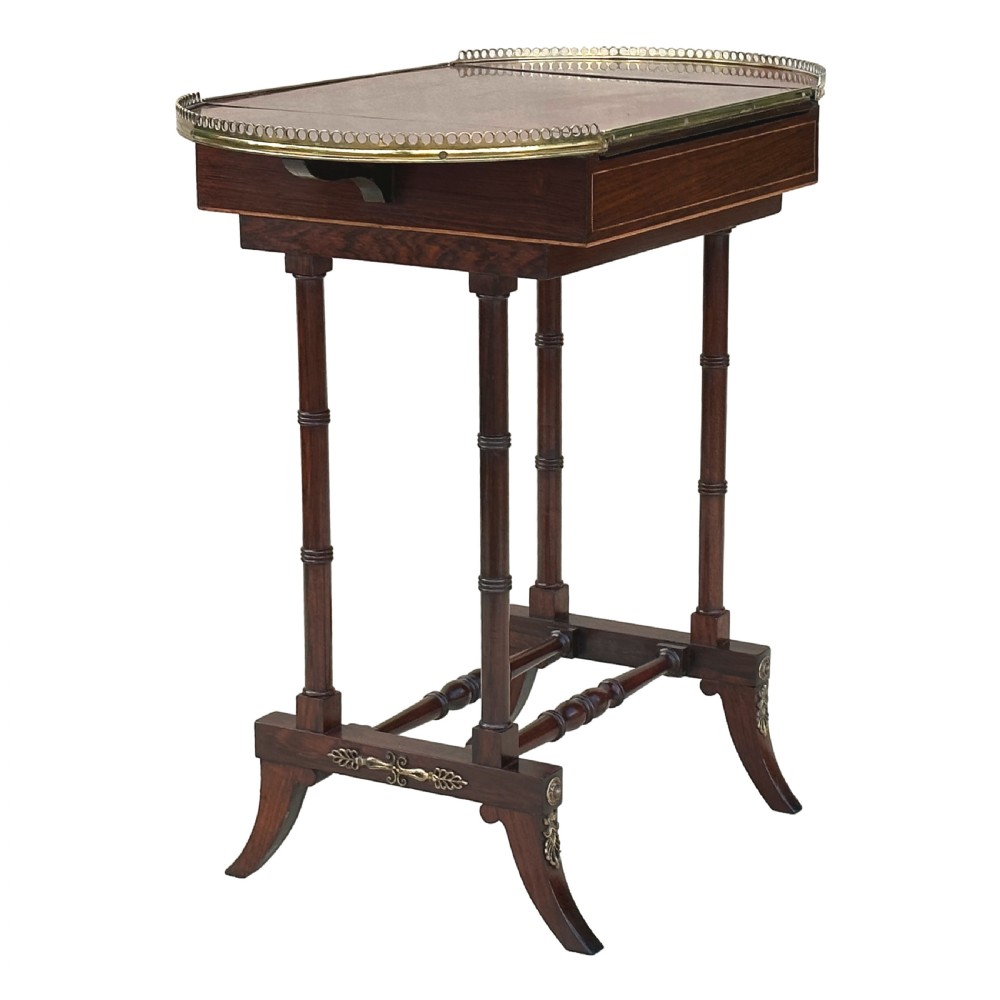 A dark rosewood Regency games table featuring slender ring-turned legs, a pierced brass gallery railing on top, and brass mounts on splayed feet. View VIII