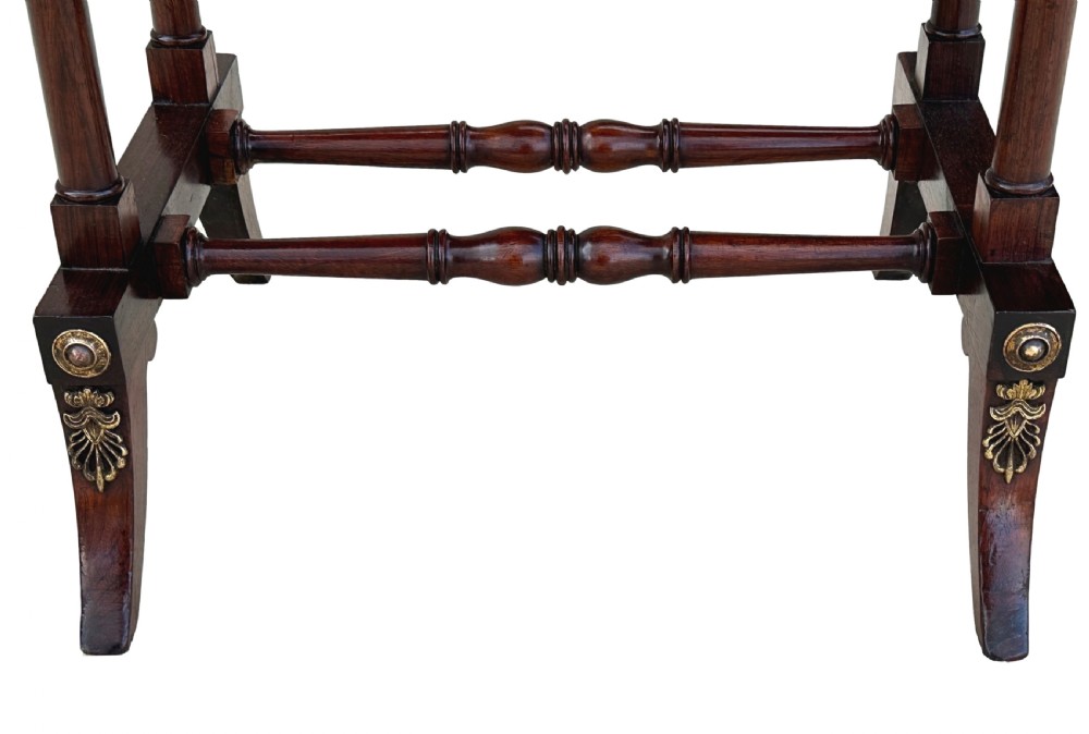 A dark rosewood Regency games table featuring slender ring-turned legs, a pierced brass gallery railing on top, and brass mounts on splayed feet. View X
