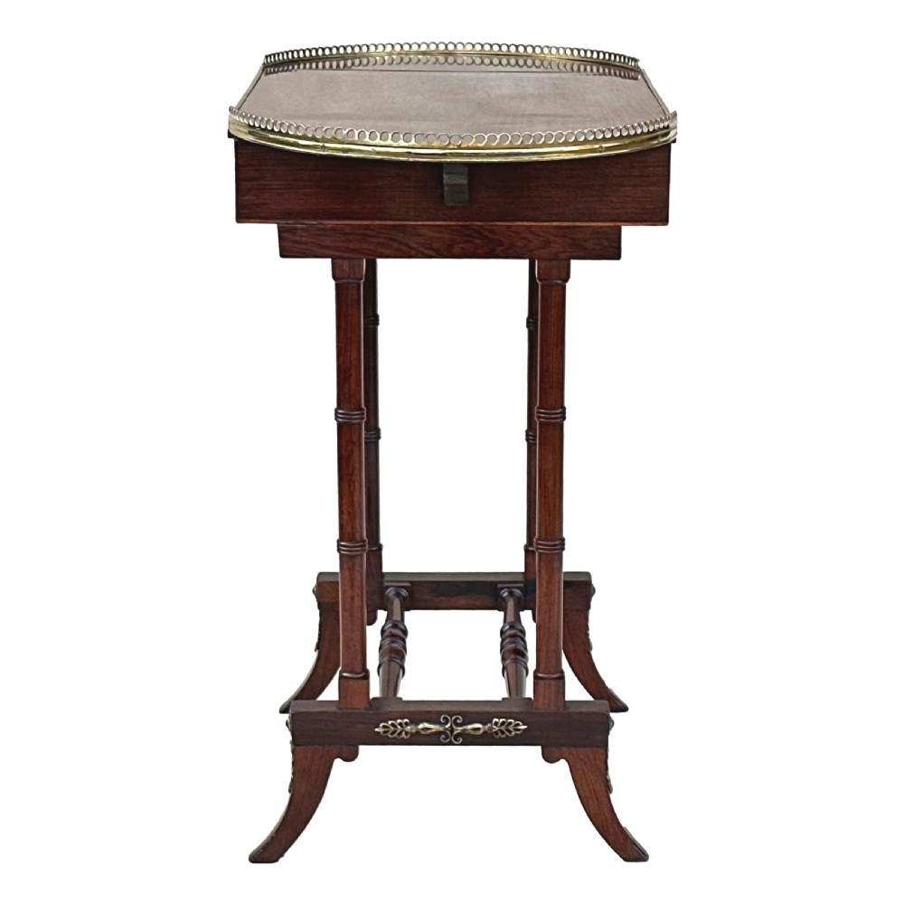 A dark rosewood Regency games table featuring slender ring-turned legs, a pierced brass gallery railing on top, and brass mounts on splayed feet. View XI