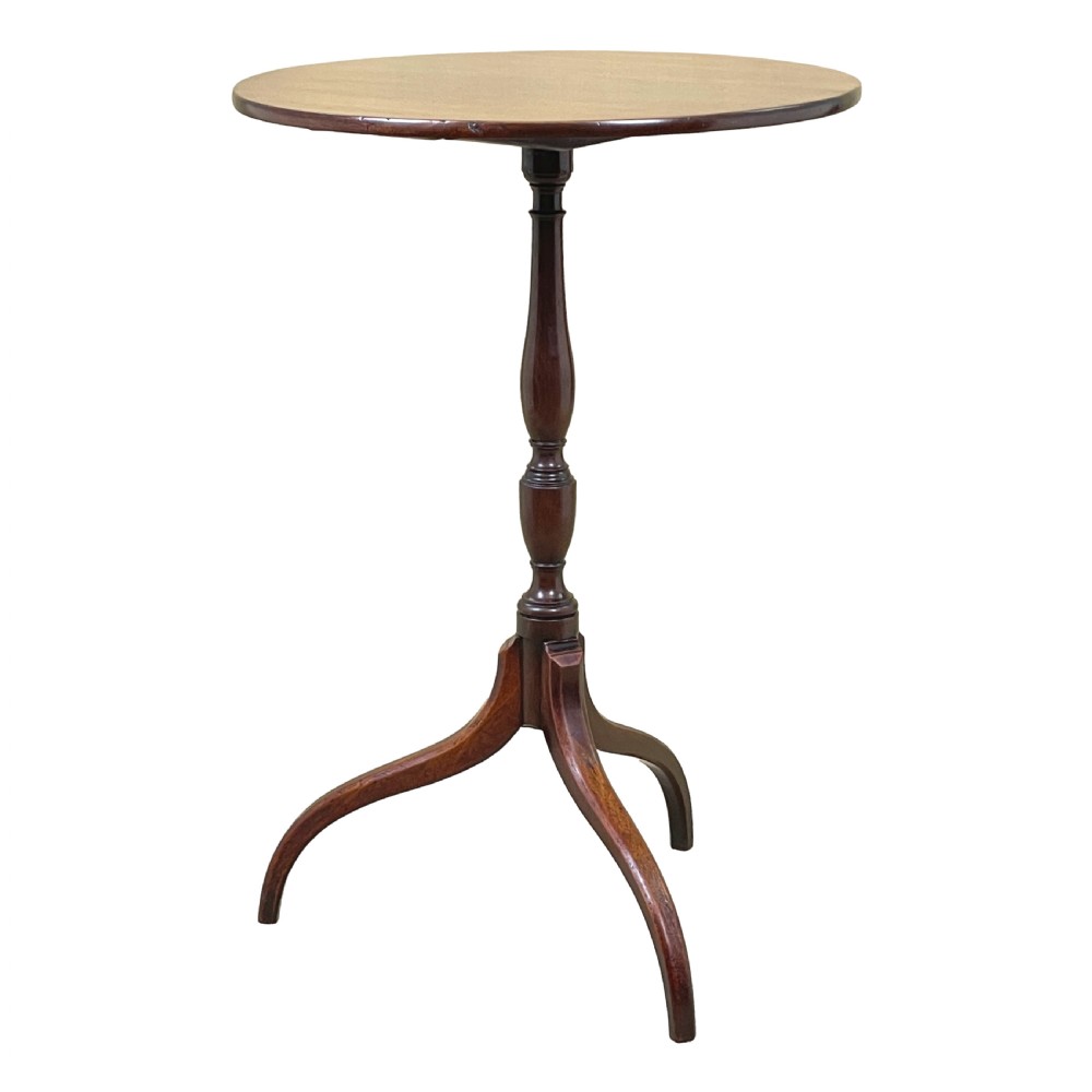 A Regency mahogany wine table featuring a flat circular top raised on a turned column and a three-legged tripod base.
