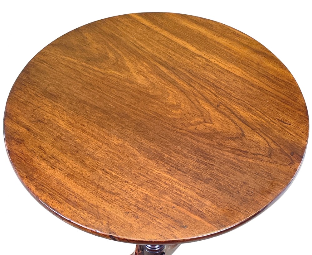 A Regency mahogany wine table featuring a flat circular top raised on a turned column and a three-legged tripod base. View VI