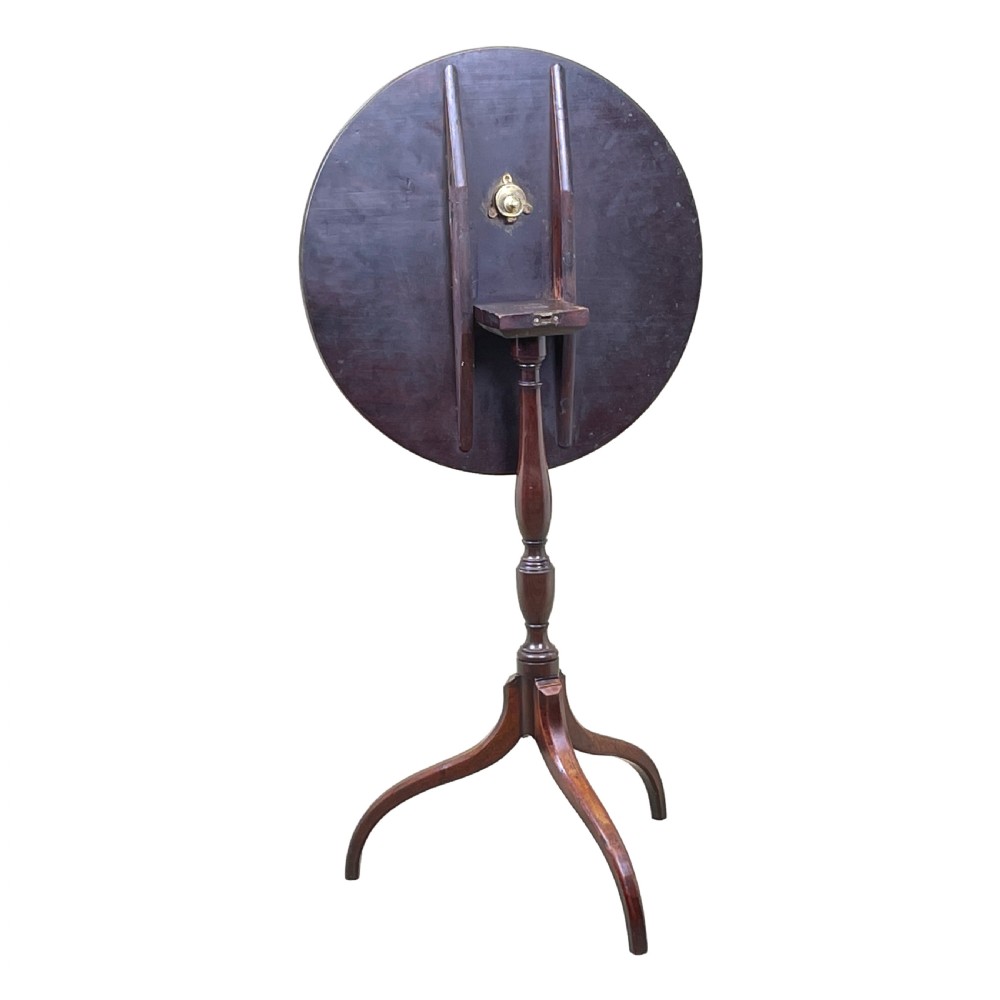A Regency mahogany wine table featuring a flat circular top raised on a turned column and a three-legged tripod base. View VII