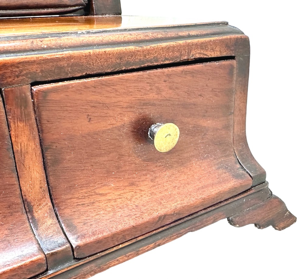 An 18th-century Georgian mahogany toilet mirror featuring a rectangular swivelling glass with a gilded inner border set above a drawer base with brass handles. View VII
