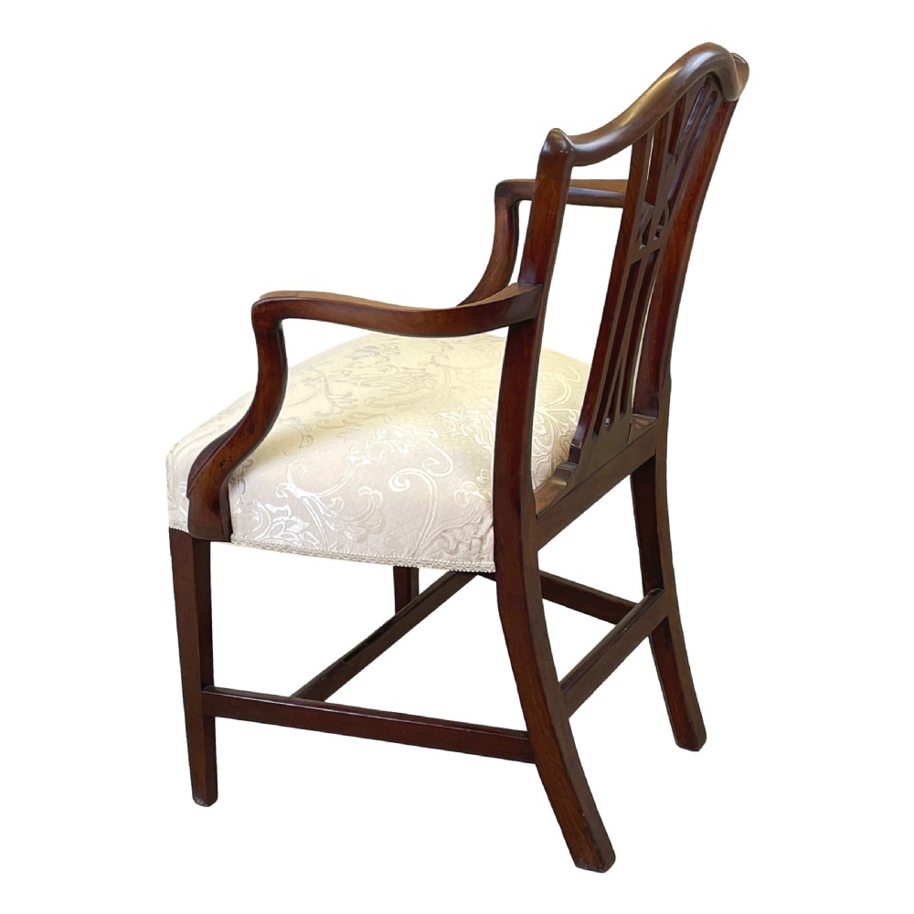 An 18th-century Georgian carved mahogany open armchair with a pierced back splat and cream patterned upholstered seat. View II