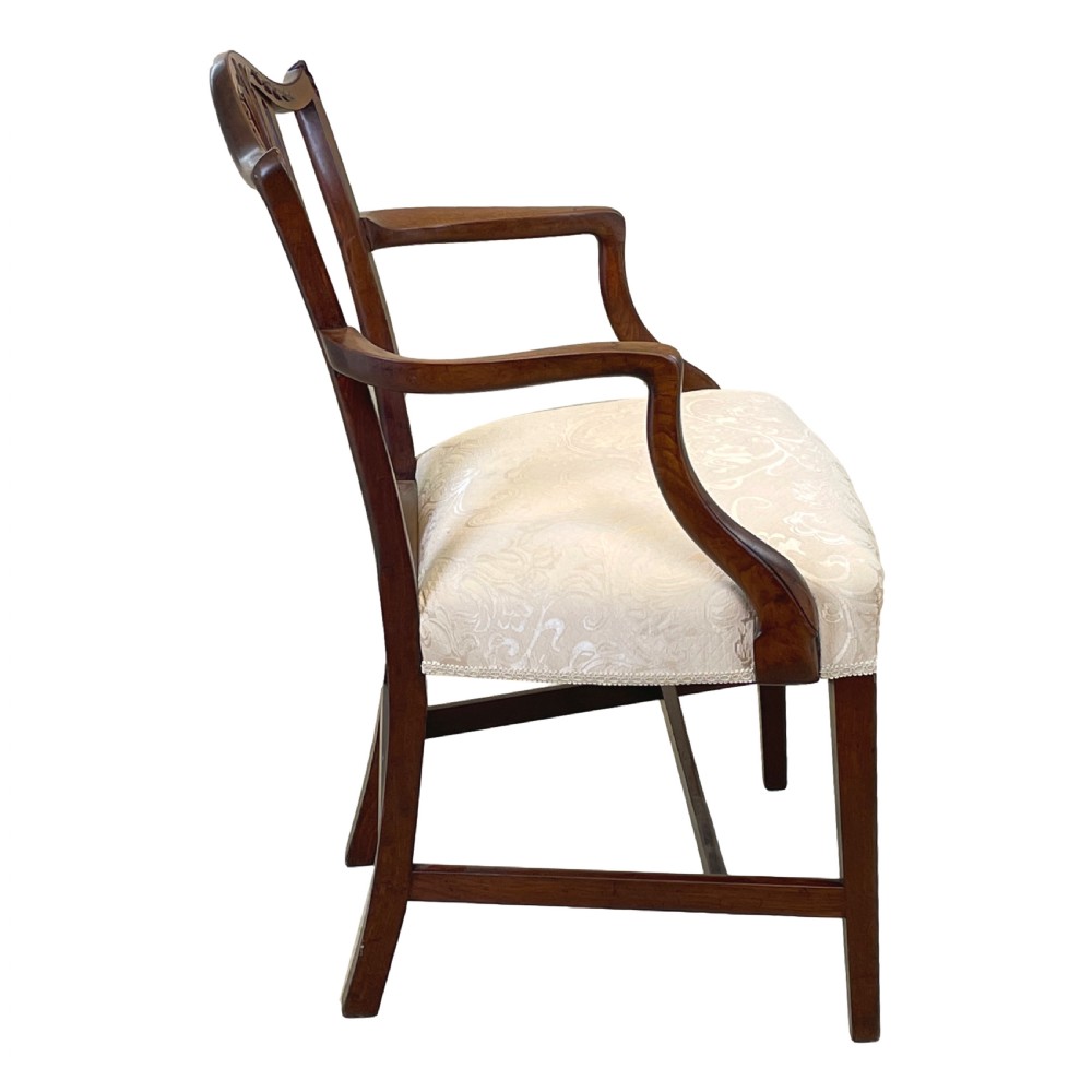 An 18th-century Georgian carved mahogany open armchair with a pierced back splat and cream patterned upholstered seat. View VII
