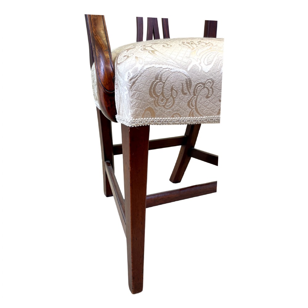 An 18th-century Georgian carved mahogany open armchair with a pierced back splat and cream patterned upholstered seat. View X
