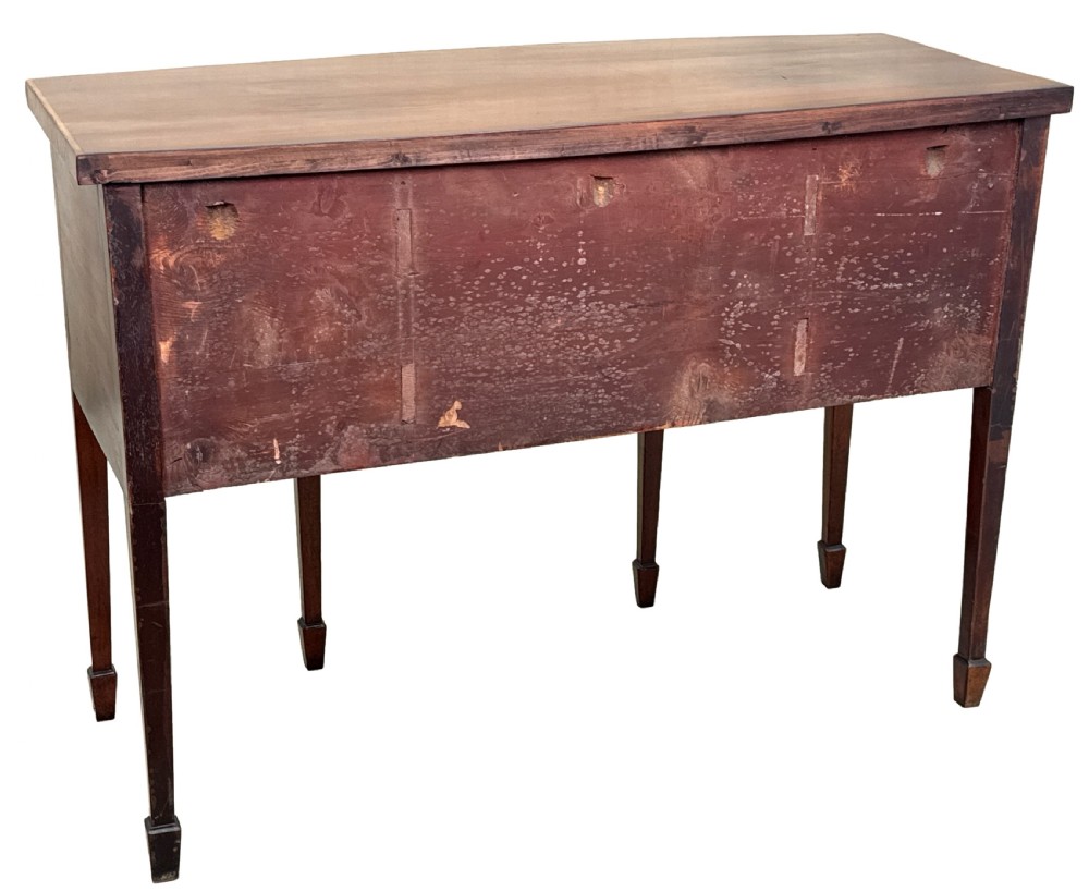 An 18th-century Georgian mahogany bowfront sideboard featuring a gently curved front, satinwood inlay, brass oval handles, and square tapered legs with spade feet. View VIII