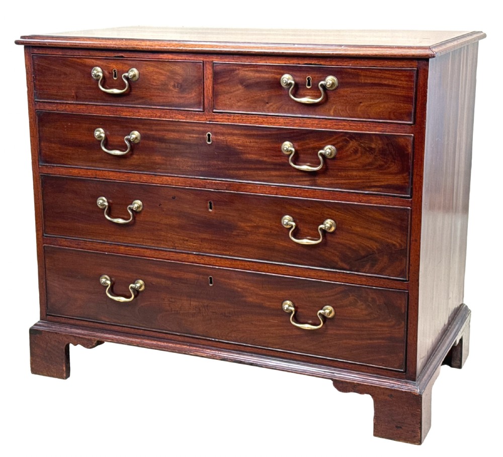 An 18th-century Chippendale mahogany chest of drawers featuring a two-over-three drawer configuration, brass swan-neck handles, keyhole escutcheons, and bracket feet.