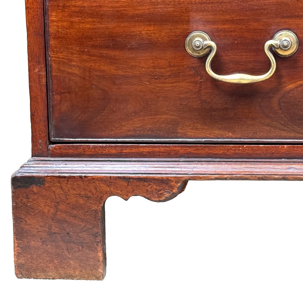 An 18th-century Chippendale mahogany chest of drawers featuring a two-over-three drawer configuration, brass swan-neck handles, keyhole escutcheons, and bracket feet. View VII