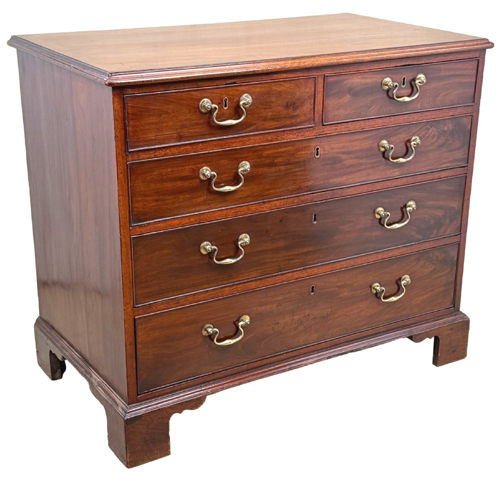 An 18th-century Chippendale mahogany chest of drawers featuring a two-over-three drawer configuration, brass swan-neck handles, keyhole escutcheons, and bracket feet. View X