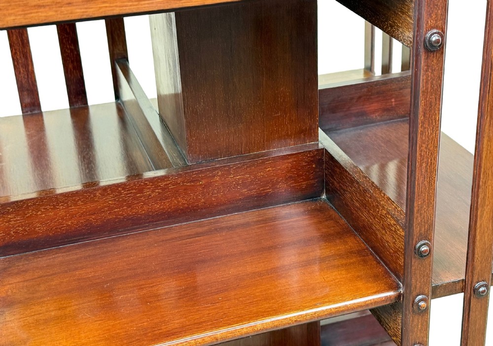 A late 19th-century square mahogany revolving bookcase featuring vertical slatted sides, open shelves, and a castored base. View V