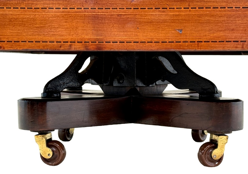 A late 19th-century square mahogany revolving bookcase featuring vertical slatted sides, open shelves, and a castored base. View VI