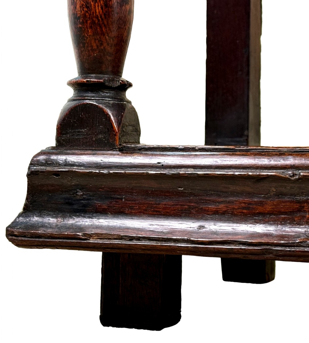 An 18th-century dark oak dresser base featuring multiple drawers with pierced brass handles, turned front legs, and a lower pot board shelf. View VIII