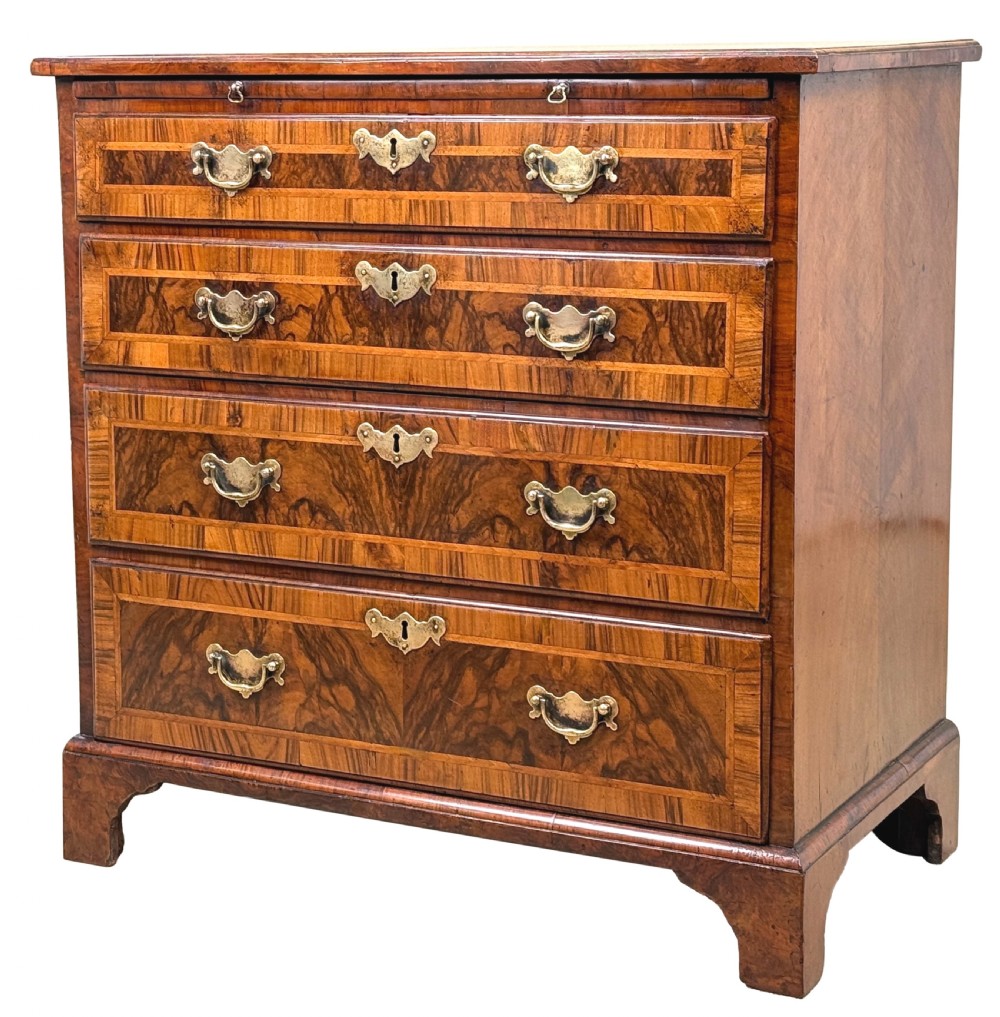 An 18th-century Georgian walnut chest of drawers featuring four graduated drawers with crossbanded borders, brass swing handles, a brushing slide, and bracket feet.