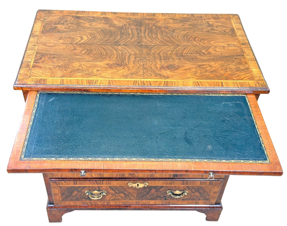 An 18th-century Georgian walnut chest of drawers featuring four graduated drawers with crossbanded borders, brass swing handles, a brushing slide, and bracket feet. View VII