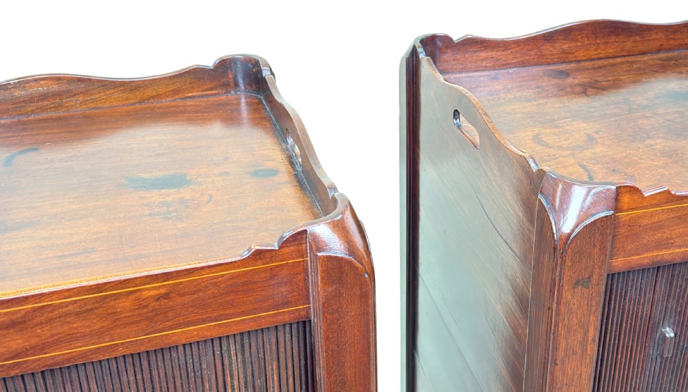 A matching pair of 18th-century mahogany bedside tables featuring gallery tops with side handles, slatted tambour doors, and drawers with brass oval handles and fine inlay. View VI