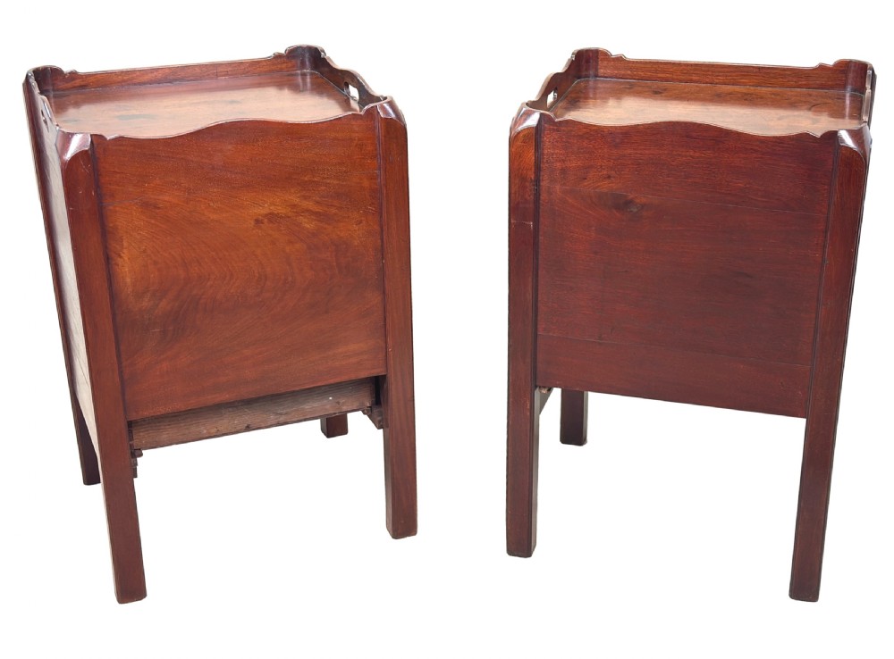 A matching pair of 18th-century mahogany bedside tables featuring gallery tops with side handles, slatted tambour doors, and drawers with brass oval handles and fine inlay. View X