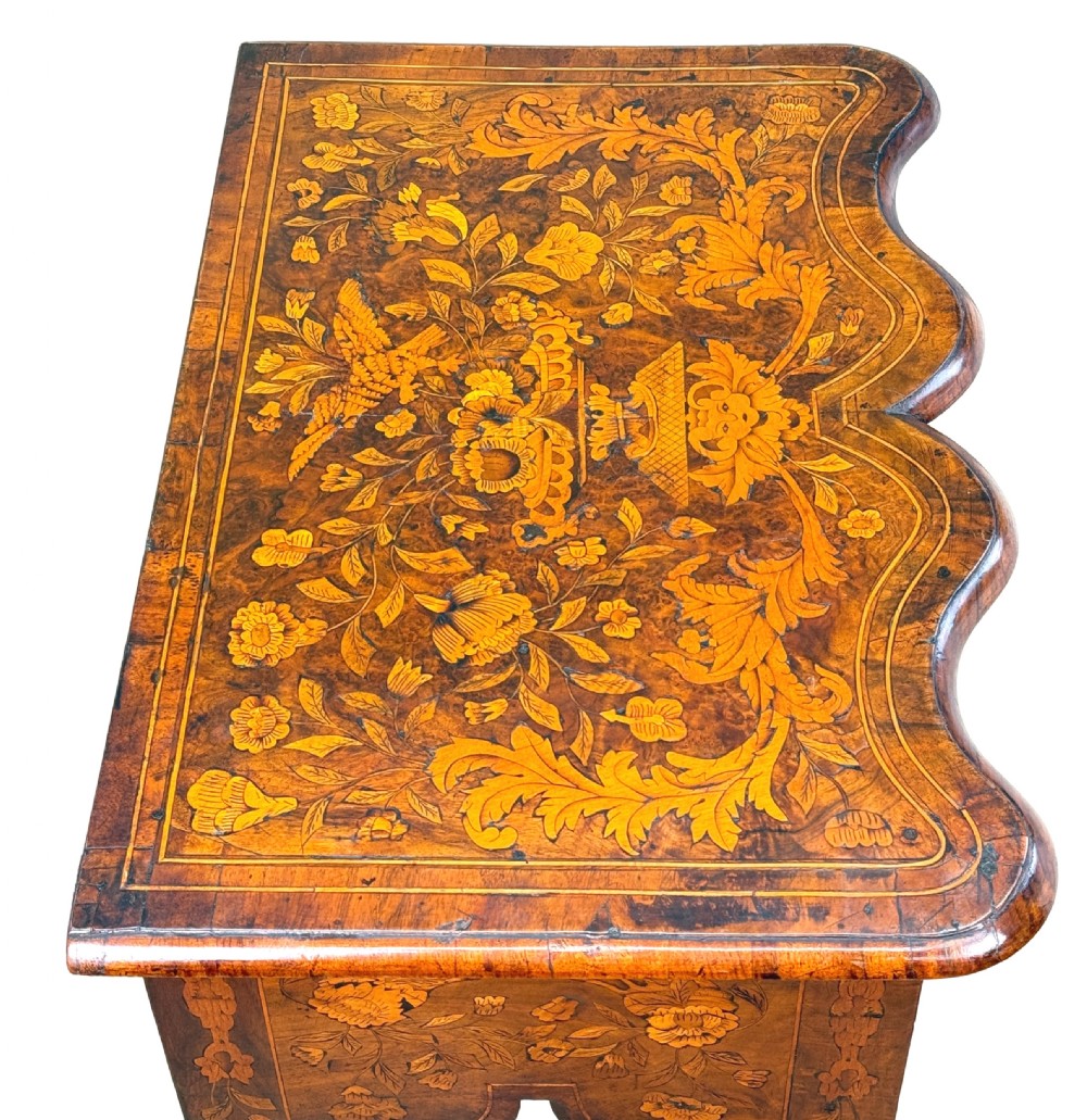 An 18th-century walnut lowboy side table decorated with intricate floral marquetry, featuring four drawers, a shaped apron with a drop finial, and cabriole legs. View V