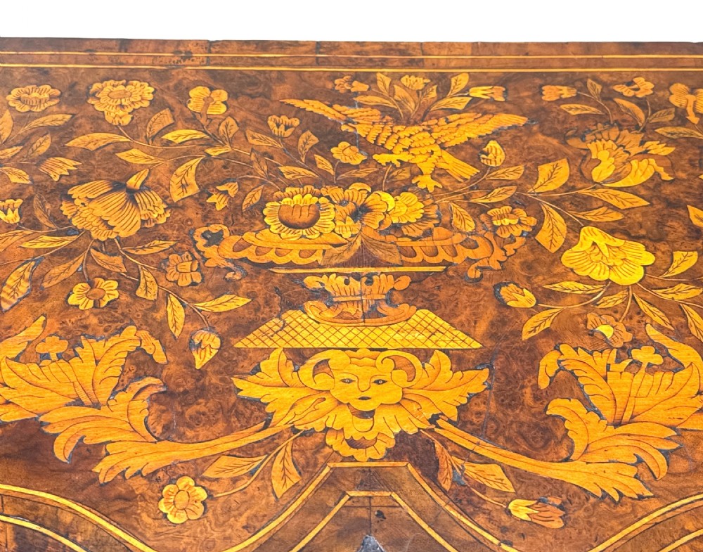 An 18th-century walnut lowboy side table decorated with intricate floral marquetry, featuring four drawers, a shaped apron with a drop finial, and cabriole legs. View VII