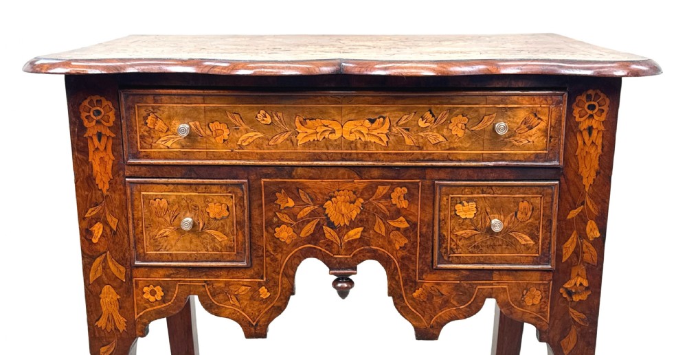 An 18th-century walnut lowboy side table decorated with intricate floral marquetry, featuring four drawers, a shaped apron with a drop finial, and cabriole legs. View VIII