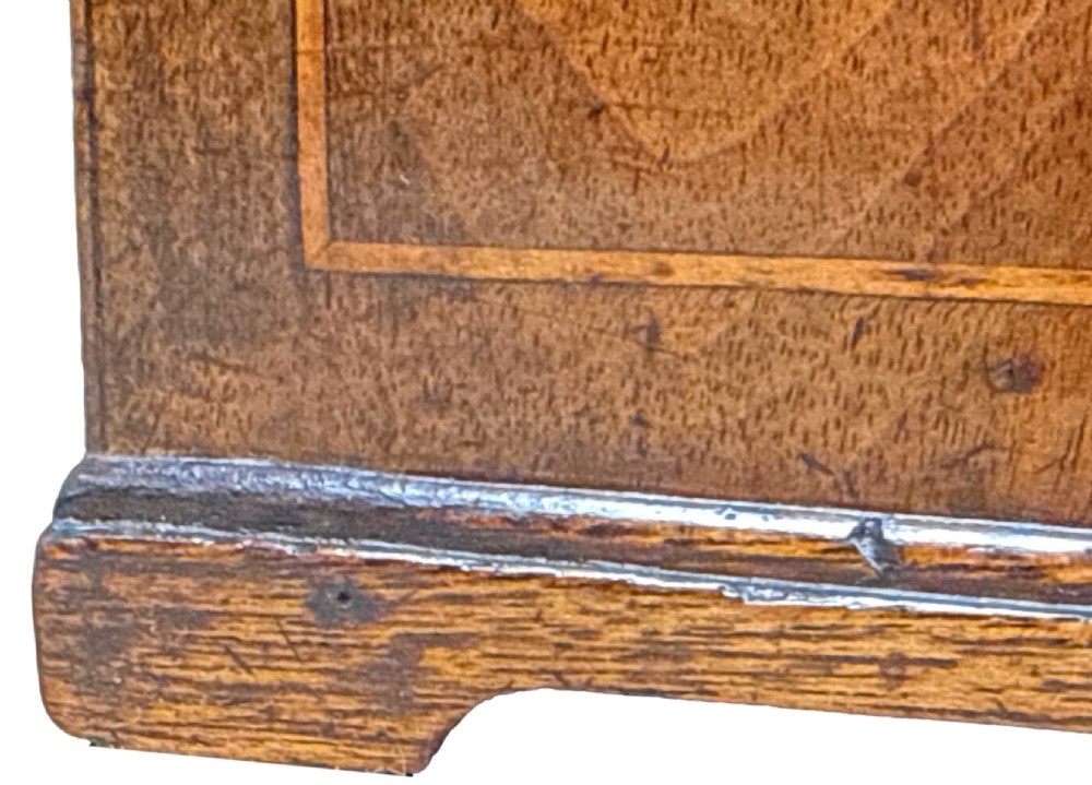 An 18th-century rectangular Georgian walnut tea caddy featuring herringbone stringing, a brass carrying handle on the lid, and a shaped brass escutcheon on the front face. View V