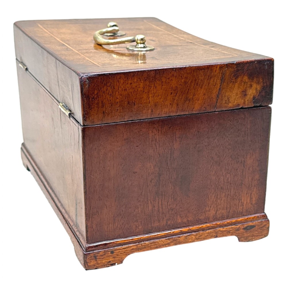 An 18th-century rectangular Georgian walnut tea caddy featuring herringbone stringing, a brass carrying handle on the lid, and a shaped brass escutcheon on the front face. View VIII