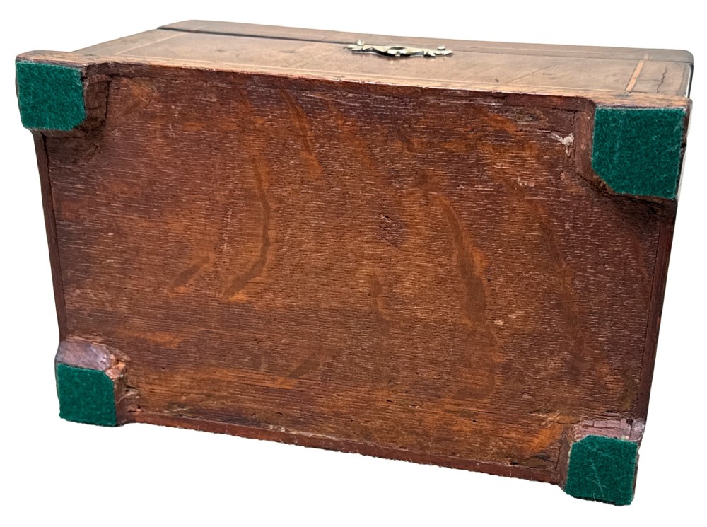 An 18th-century rectangular Georgian walnut tea caddy featuring herringbone stringing, a brass carrying handle on the lid, and a shaped brass escutcheon on the front face. View XI