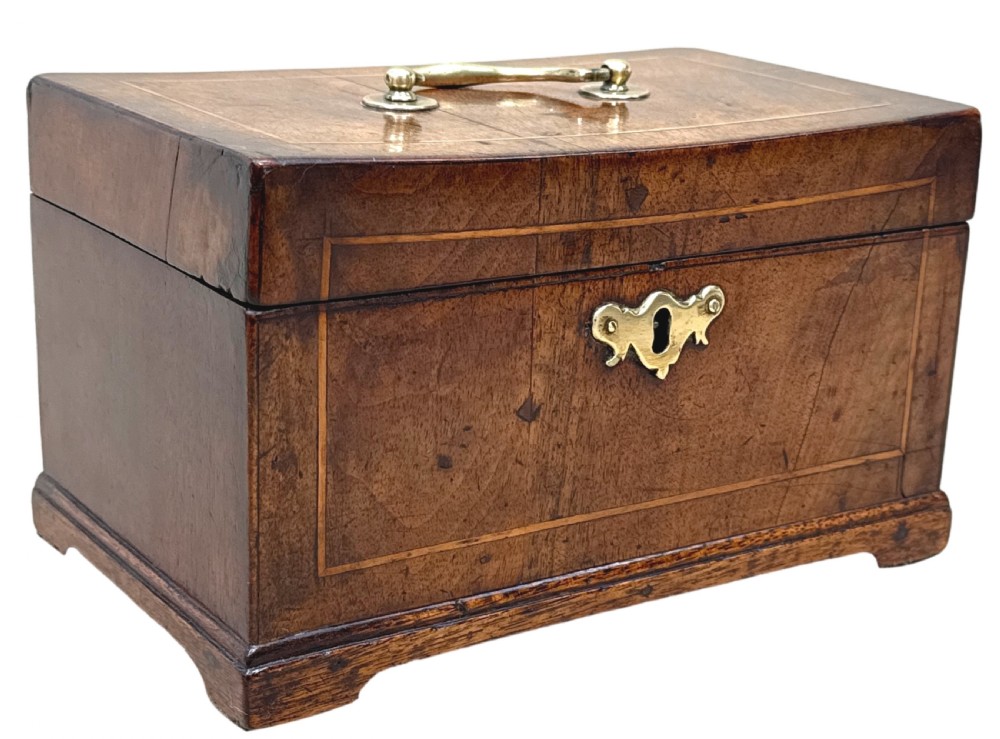 An 18th-century rectangular Georgian walnut tea caddy featuring herringbone stringing, a brass carrying handle on the lid, and a shaped brass escutcheon on the front face. View XIII