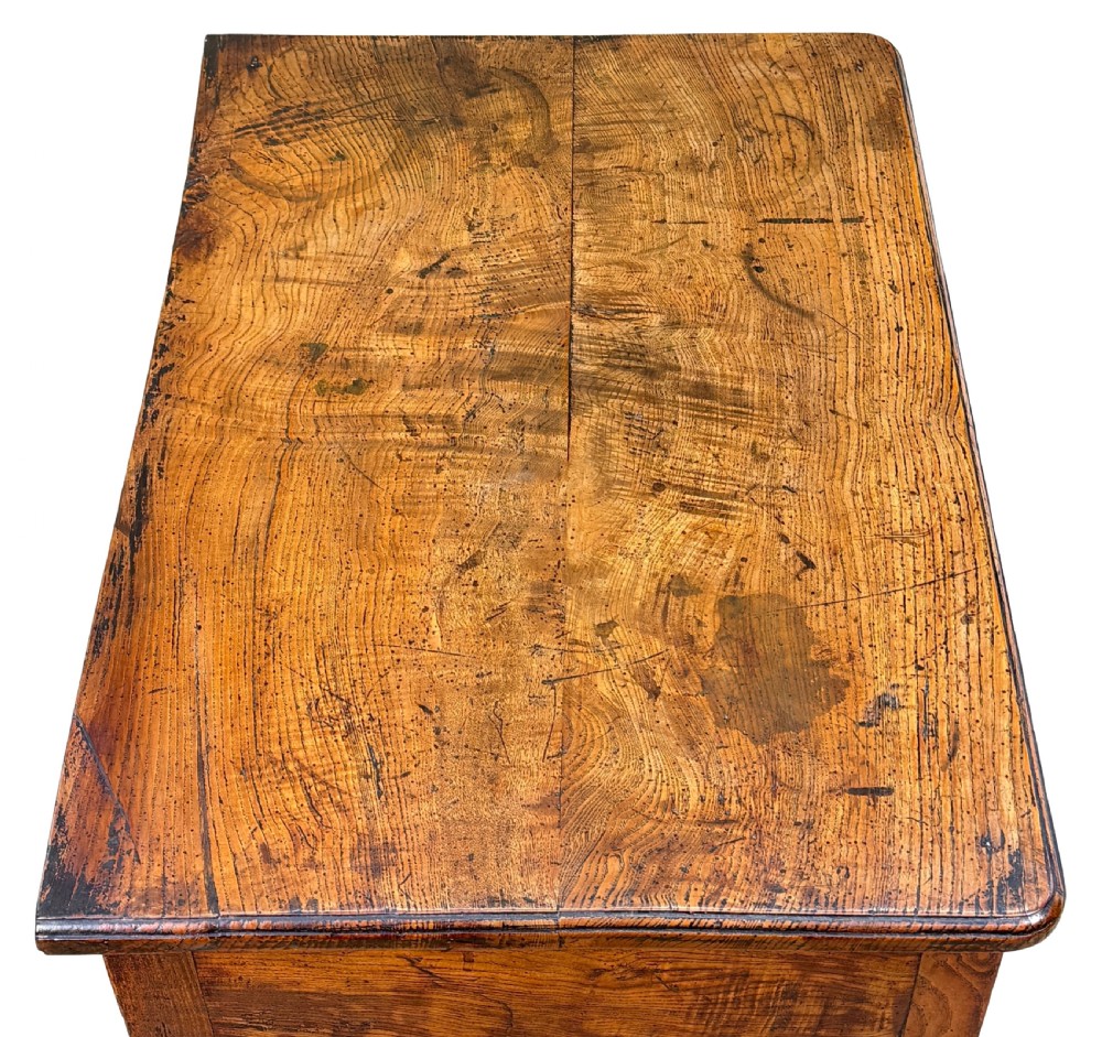 An 18th-century Georgian quilted elm lowboy featuring three drawers with brass handles, a shaped kneehole apron, and four slender cabriole legs. View III