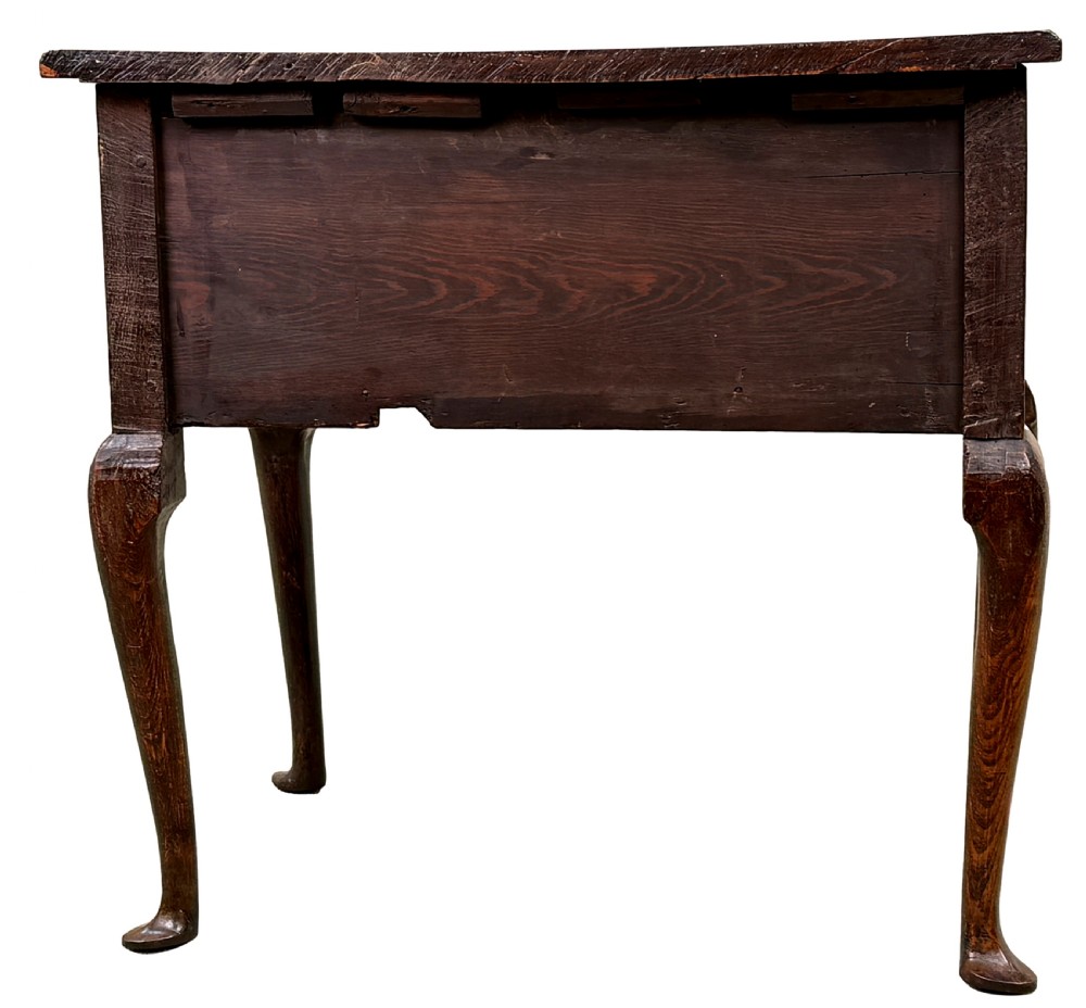 An 18th-century Georgian quilted elm lowboy featuring three drawers with brass handles, a shaped kneehole apron, and four slender cabriole legs. View IX
