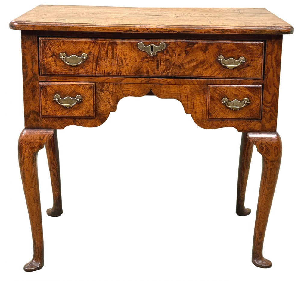 An 18th-century Georgian quilted elm lowboy featuring three drawers with brass handles, a shaped kneehole apron, and four slender cabriole legs. View XI