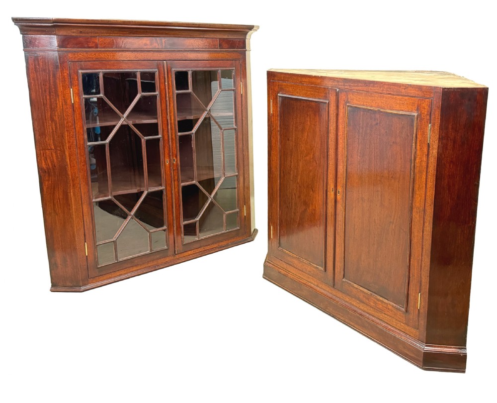A tall two-part Georgian mahogany corner cabinet featuring upper astragal glazed doors and panelled lower doors. View III
