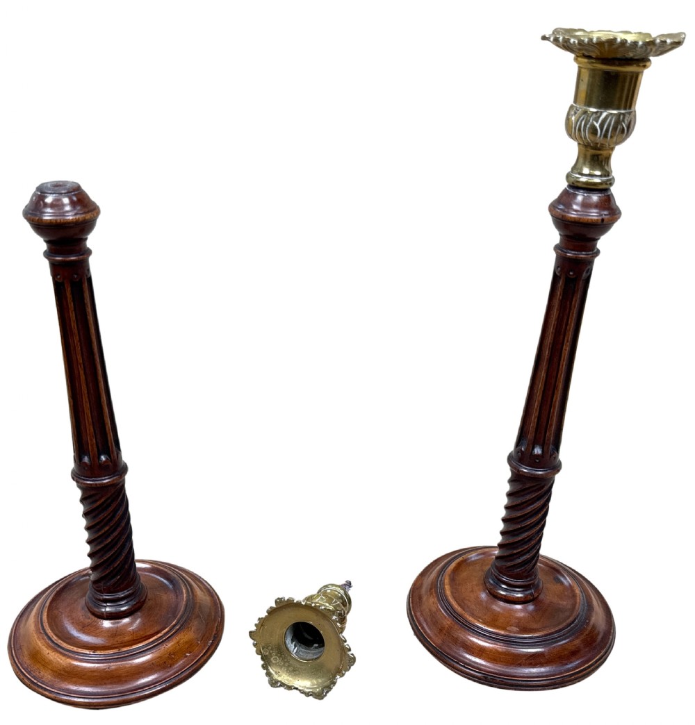 A pair of 18th-century mahogany candlesticks featuring fluted and spiral-twisted stems with brass nozzles set on circular turned bases. View II