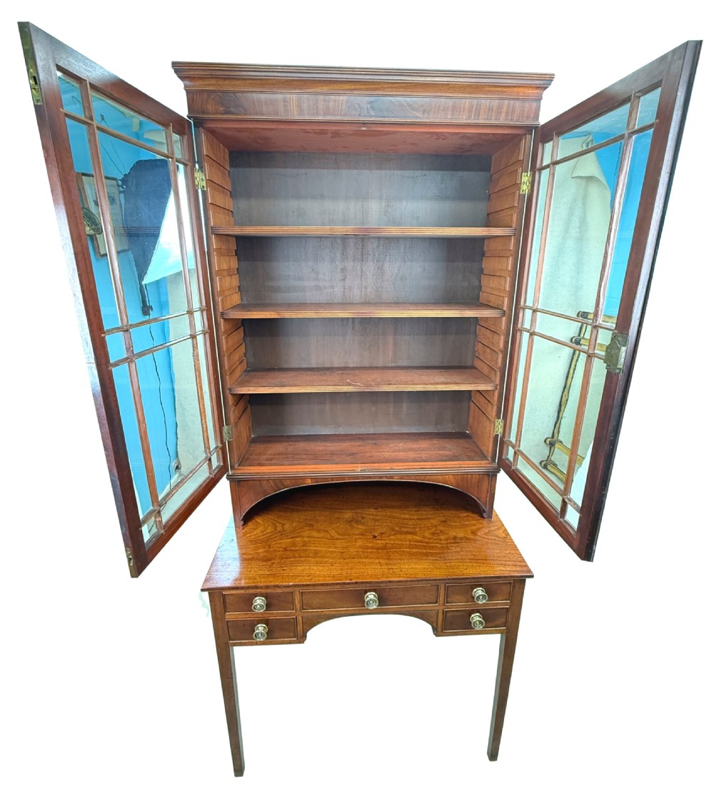 An 18th-century Georgian mahogany display cabinet featuring astragal glazed upper doors above a writing desk base with drawers and tapered legs. View III