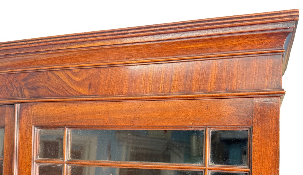 An 18th-century Georgian mahogany display cabinet featuring astragal glazed upper doors above a writing desk base with drawers and tapered legs. View VIII