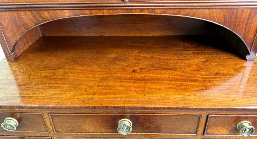An 18th-century Georgian mahogany display cabinet featuring astragal glazed upper doors above a writing desk base with drawers and tapered legs. View XIV