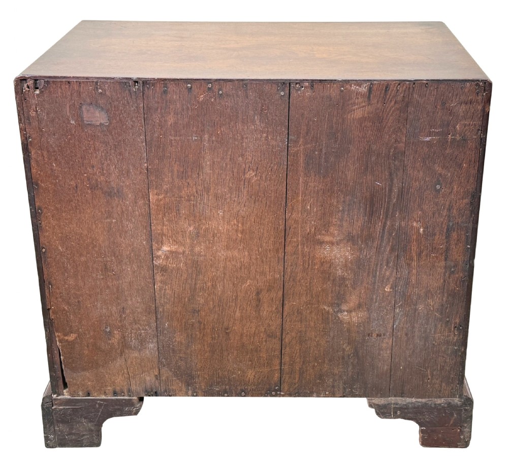 An 18th-century Georgian mahogany chest of drawers featuring four graduated drawers, brass swan-neck handles, a pull-out brushing slide, and sturdy bracket feet. View X