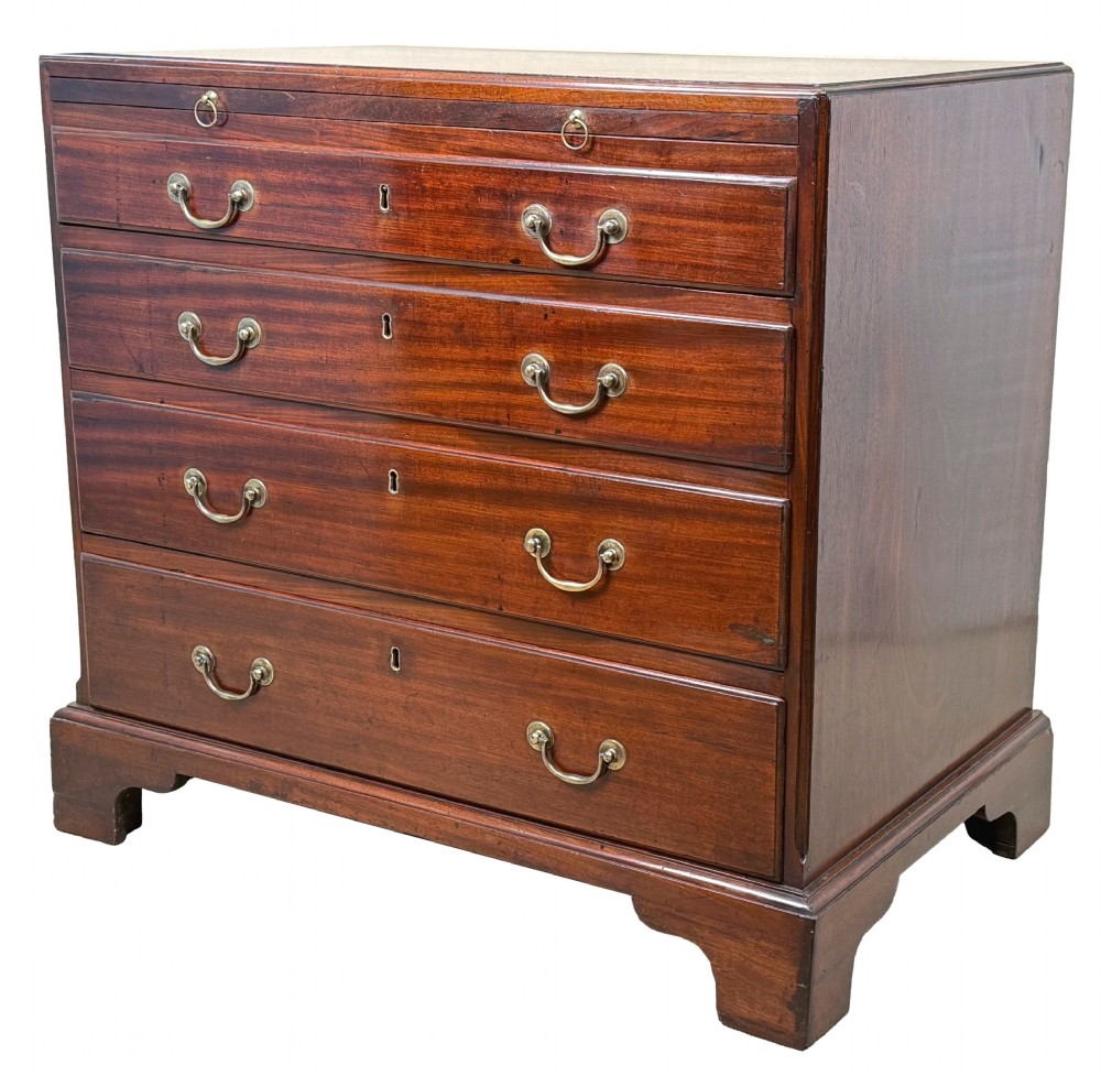 An 18th-century Georgian mahogany chest of drawers featuring four graduated drawers, brass swan-neck handles, a pull-out brushing slide, and sturdy bracket feet.