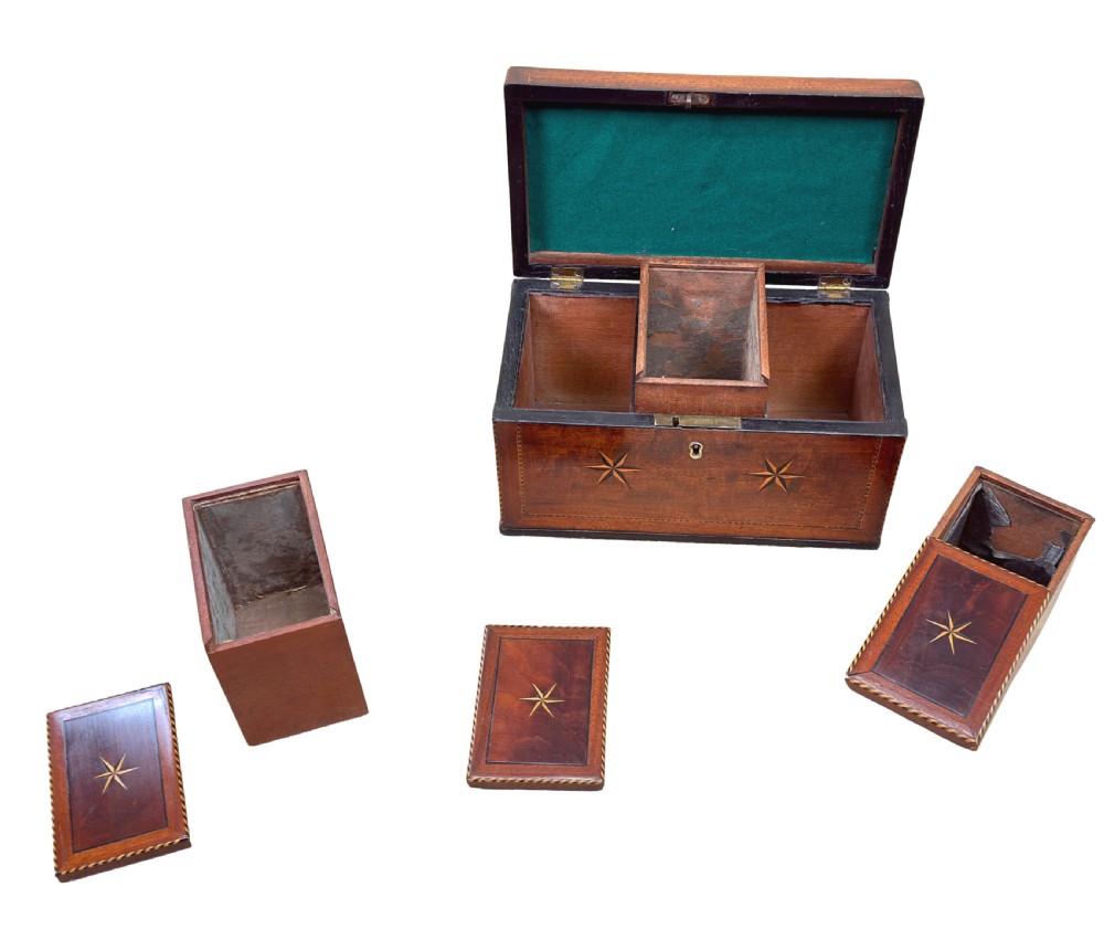 A rectangular 18th-century mahogany tea caddy featuring inlaid wooden star motifs on the front panel and a brass ring handle on top. View VI