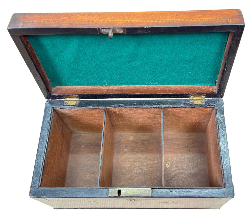A rectangular 18th-century mahogany tea caddy featuring inlaid wooden star motifs on the front panel and a brass ring handle on top. View VII