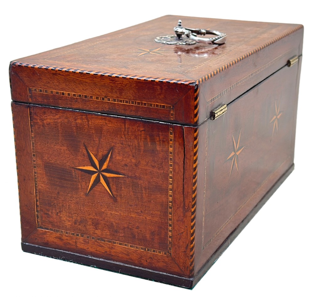A rectangular 18th-century mahogany tea caddy featuring inlaid wooden star motifs on the front panel and a brass ring handle on top. View IX