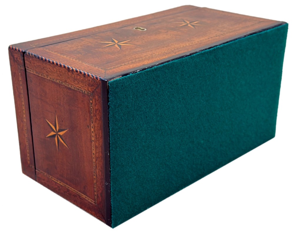 A rectangular 18th-century mahogany tea caddy featuring inlaid wooden star motifs on the front panel and a brass ring handle on top. View X
